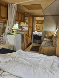 a bedroom of an rv with a bed in it at Beachfront Caravans in Chernomorets
