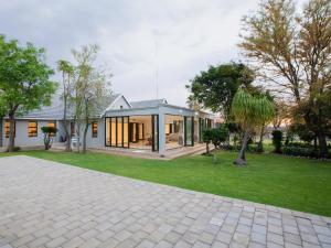 a house with a brick driveway in front of a house at Naledi@53 Private Game Farm in Brits