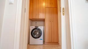 a washer and dryer in a small room at Villa28 Harmony in Paleros +9 photos