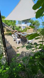 a group of chairs and a table with an umbrella at Beachfront Caravans in Chernomorets
