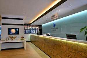 a lobby with a reception counter and a table at Fountains Hotel by Neighbourgood in Cape Town