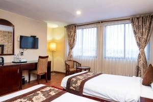 Rúm í herbergi á Hotel Mirage Regency