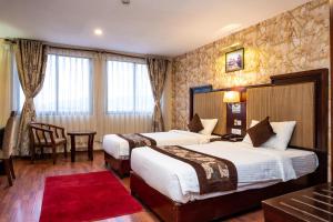 Rúm í herbergi á Hotel Mirage Regency