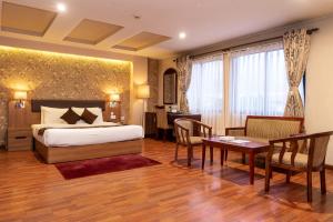 Rúm í herbergi á Hotel Mirage Regency