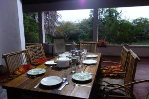 a wooden table with plates and dishes on it at Juani Pangani in Pangani