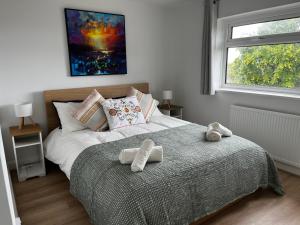 a bedroom with a bed with two towels on it at Entire home in Gronant, United Kingdom in Talacre