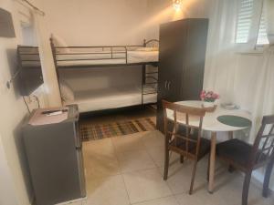 a small room with a table and a bunk bed at Laertis Studio in Kattavía