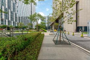 a sidewalk in a city with tall buildings at Bulgari Serviced Residences Guangzhou in Guangzhou