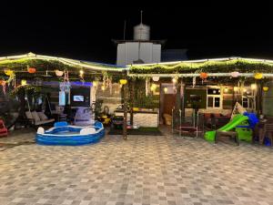 a patio with a playground with a slide at Urban Nest in Dehradun