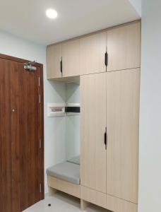 a large wooden cabinet with a bench in a room at The Emerald Golf View in Thuan An +4 photos