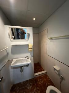 a person taking a picture of a bathroom with a sink at เวลาสุข in Phra Nakhon Si Ayutthaya