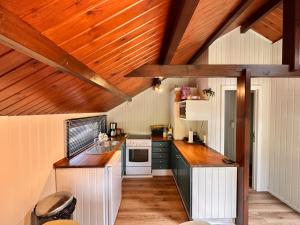 a kitchen with wooden ceilings and wooden counters at Golfchalets Evergreen - Four Seasons in Durbuy