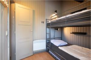a bunk bed in a room with a door and a bed sidx sidx at Golfchalets Evergreen - Four Seasons in Durbuy