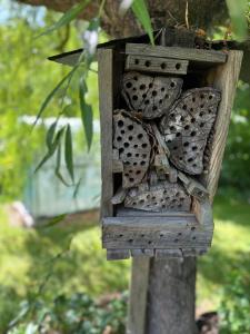 a wooden bird house sitting on a tree at Arduinna's Nest B&B in Neufchâteau