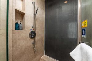 a shower with a glass door in a bathroom at Bulgari Serviced Residences Guangzhou in Guangzhou