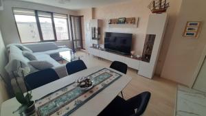 a living room with a table and a couch at Apartment Tuthon in Pomorie