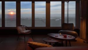 a living room with a view of the ocean at Valdemosa one in De Haan