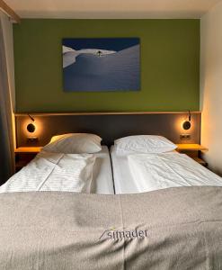 Cama ou camas em um quarto em Hotel Simader