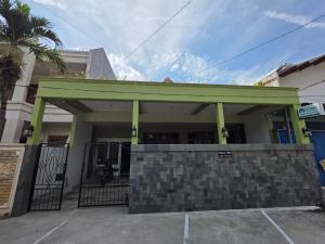 AlastuwoにあるGreen Living Homeの駐車場に緑の張り出しがある建物