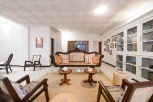 a living room with a couch and chairs at Eden Kandy in Kandy