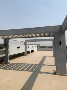 an empty parking lot with a large concrete structure at Golf news inspire living in Benin City