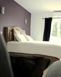 a bedroom with two beds and a window at Hôtel-Restaurant Belle'man in Longevelle-sur-Doubs