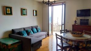 a living room with a couch and a table at Vesto VISTA in Marone