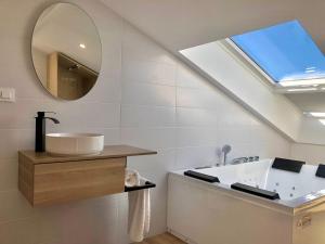 a bathroom with a sink and a mirror at A caseta de Sil in Lira +55 photos