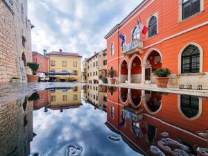 a reflection of buildings in the water of a canal at Apartment Ane in Bale