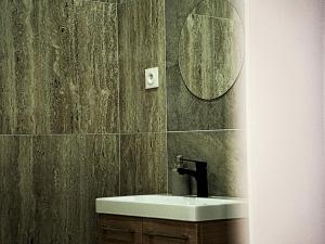a bathroom with a sink and a mirror at Hôtel-Restaurant Belle'man in Longevelle-sur-Doubs +23 photos