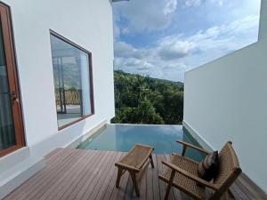 a view from the balcony of a house with two chairs at Grand Abinawahill in Lovina