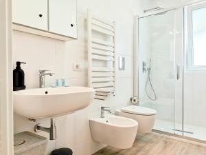 a white bathroom with a sink and a toilet at Blu Blu Apartment in Bari +29 photos