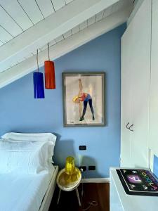 a bedroom with a bed and a painting on the wall at Vanessa's Art Rooftop Attic - City View - San Fedele, Historic Center Como in Como