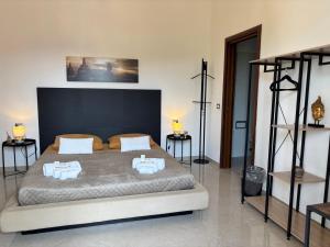 a bedroom with a large bed and two tables at B&B IL TULIPANO free private parking in Como