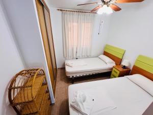 a small room with a bed and a couch at Residencia Dos Mares I, Bloque 3, Escalera 1, 2º C in La Manga del Mar Menor +30 photos