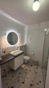un bagno con lavandino, WC e specchio di Maloves Resort & Spa, pokoje w bocznych budynkach a Władysławowo Altre 127 foto