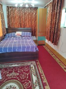 a bedroom with a bed and a red carpet at Camping malul marii Corbu in Corbu