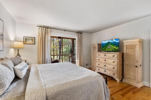 a bedroom with a bed and a dresser and a window at Buckanoe Condo -Hiking Trails Wood-Burning Fireplace Community Pools in Holcomb +24 photos