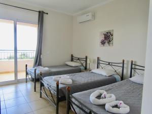 A bed or beds in a room at Barbati Beach Apartments Még 37 kép