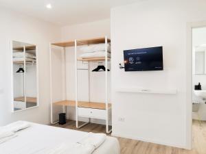 a bedroom with a bed and a tv on a wall at Katablu in Bari +34 photos
