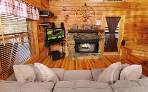 a living room with a couch and a fireplace at Tennessee Treasure in Pigeon Forge