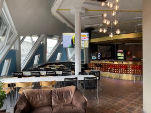 a room with a table and chairs and a bar at Blue Hostel Bláu Fjöll in Vestmannaeyjar