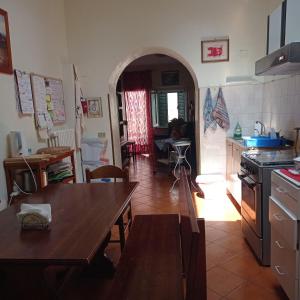 a kitchen with a table and a dining room at Guest Art House Aurora in Pissignano +2 photos