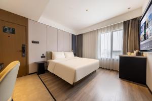 Postel nebo postele na pokoji v ubytování Atour Hotel Guangzhou Baiyun Jiahe Hebian