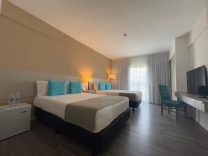 Ένα ή περισσότερα κρεβάτια σε δωμάτιο στο Days lnn Hotel Parque Termal Dolores +26 φωτογραφίες
