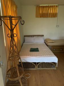 a small bed in a room with a bed frame at Peaceful lakeview in Rānīpauwa