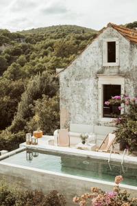 a villa with a swimming pool and a house at Family friendly house with a swimming pool Selca, Brac - 24224 in Selca