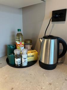a tea kettle and other ingredients on a counter at Central apartment from 2025 in Alta +3 photos
