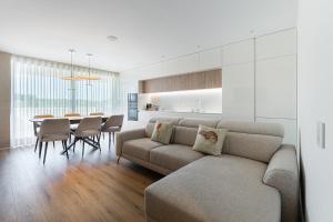 a living room with a couch and a table at GuestReady - A charming place in a private condo in Apúlia