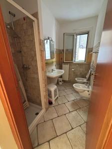 a bathroom with a toilet and a sink and a shower at Residence IL BORGO 35 in Tortoreto Lido